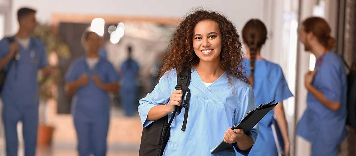 En premier pan une étudiante en formation médicale, d'autres étudiants en arrière-plan