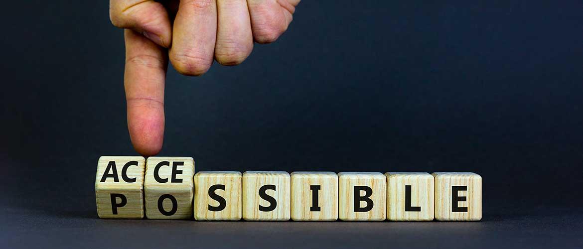Un doigt fait pivoter les trois premières lettres du mot "Possible" pour le transformer en le mot "Accessible"